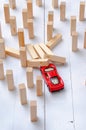 The red toy car overcomes all obstacles in the way and barriers reaching the goal and knocking down obstacles in its path. Royalty Free Stock Photo