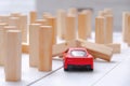 The red toy car overcomes all obstacles in the way and barriers reaching the goal and knocking down obstacles in its path. Royalty Free Stock Photo