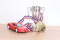 Red toy car with silver sporting trophy