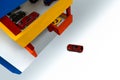 Red toy car SUV,entrance multi-level wooden garage.Concept finding free park space in city.Multi-storey parking complex