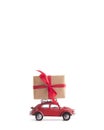 Red toy car Volkswagen Beetle with creative wrapped box on white background Royalty Free Stock Photo