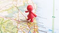 A red toy figure standing over Newcastle Upon Tyne on a map of England portrait Royalty Free Stock Photo