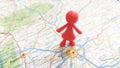 A red toy figure standing on a map of Munich Germany