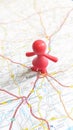 A red toy girl standing on Valladolid on a map of Spain portrait