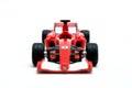 Red toy motor racing car, front view on white background. Royalty Free Stock Photo