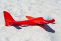 Red toy plane on the sand close up Royalty Free Stock Photo