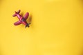 Red toy plane on yellow background Royalty Free Stock Photo