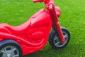 Red scooter on artificial grass