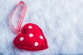 Red toy suave heart on a frosty white snow background. Love and St. Valentine concept.