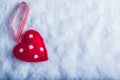 Red toy suave heart on a frosty white snow background. Love and St. Valentine concept. Royalty Free Stock Photo