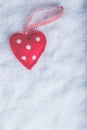 Red toy suave heart on a frosty white snow background. Love and St. Valentine concept.