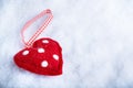 Red toy suave heart on a frosty white snow winter background. Love and St. Valentine concept