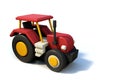 Red toy tractor vehicle, simple volume on white background Royalty Free Stock Photo