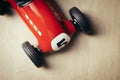 Red toy vintage racing car close up still detail on a wooden surface Royalty Free Stock Photo