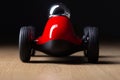 Red toy vintage racing car close up still detail on a wooden surface Royalty Free Stock Photo