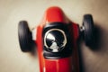 Red toy vintage racing car close up still detail on a wooden surface Royalty Free Stock Photo