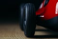 Red toy vintage racing car close up still detail on a wooden surface Royalty Free Stock Photo