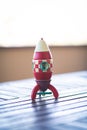 Red toy wooden vintage rocket toy on a wooden table