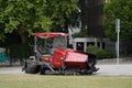 Red tracked paver without driver is parked on the street ready for overlay work with road asphalt on an existing surface. Royalty Free Stock Photo