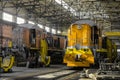 Red traction locomotives on serviced at a repair depot