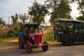 Red tractor behind a tourist shuttle in Rajiv Gandhi National Park in Nagarhole, Karnataka, India