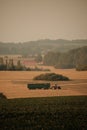 red tractor in a distant field Royalty Free Stock Photo