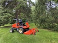Red tractor lawn mower green grass Royalty Free Stock Photo