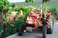 Red tractor and pink flowers in Village