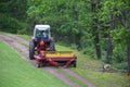 Red Tractor Pulling Disco Across Dirt Path Royalty Free Stock Photo