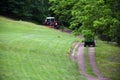 Red Tractor Pulling Disco Across Dirt Path Royalty Free Stock Photo