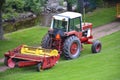 Red Tractor Pulling Disco Across Dirt Path Royalty Free Stock Photo