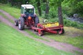 Red Tractor Pulling Disco Across Dirt Path Royalty Free Stock Photo