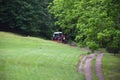 Red Tractor Pulling Disco Across Dirt Path Royalty Free Stock Photo