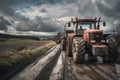 Red tractor rolling down muddy road with tire tread marks Royalty Free Stock Photo