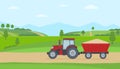 Red tractor with trailer on rural landscape background.