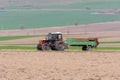 Red tractor transporting domestic animal excrements