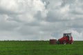 Red tractor transporting straw bales Royalty Free Stock Photo