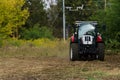 Red tractor working on field. Rural place. Royalty Free Stock Photo