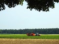 Tractor working in potato field, Lithuania Royalty Free Stock Photo