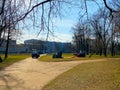 Red tractors trucks in spring city park. Cleaning. Early spring. Works. Sunny spring day. Royalty Free Stock Photo