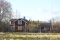 Red traditional cottages and white windows on a meadow Royalty Free Stock Photo