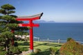 Red traditional Japanese gate torii with blue sea and mountains Royalty Free Stock Photo