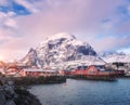 Red traditional rorbuer in small village at sunset in winter