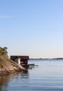 Red, traditional Swedish boathouse by the sea in the Stockholm archipelago, Dalaro, Sweden.