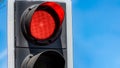Red traffic light on blue sky background Royalty Free Stock Photo