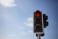 Red traffic light. Blue sky with few clouds background. Close up under view, copyspace. Royalty Free Stock Photo