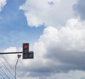 Red traffic light with blue sky and rain cloud background Royalty Free Stock Photo