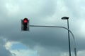 Red traffic light on a cloudy sky background with copy space for your text Royalty Free Stock Photo