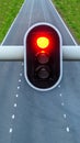 Red traffic light with empty highway on background, concept for stop, caution and pessimism Royalty Free Stock Photo