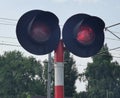 Red traffic light in front of an oncoming train. Royalty Free Stock Photo